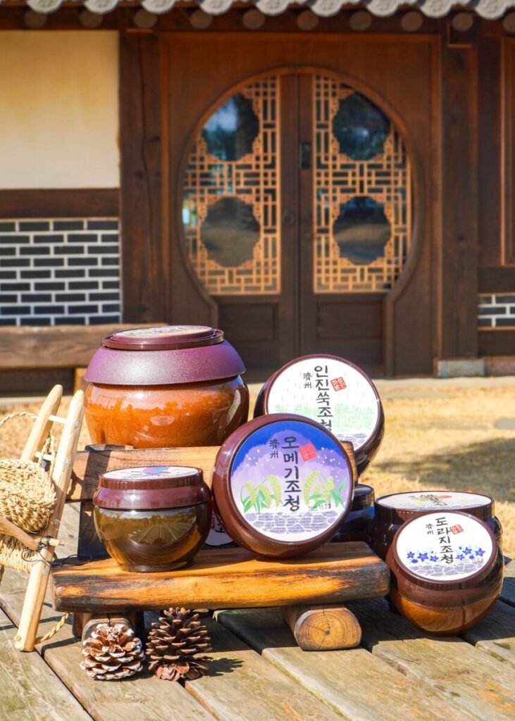 a wooden table topped with jars and containers
