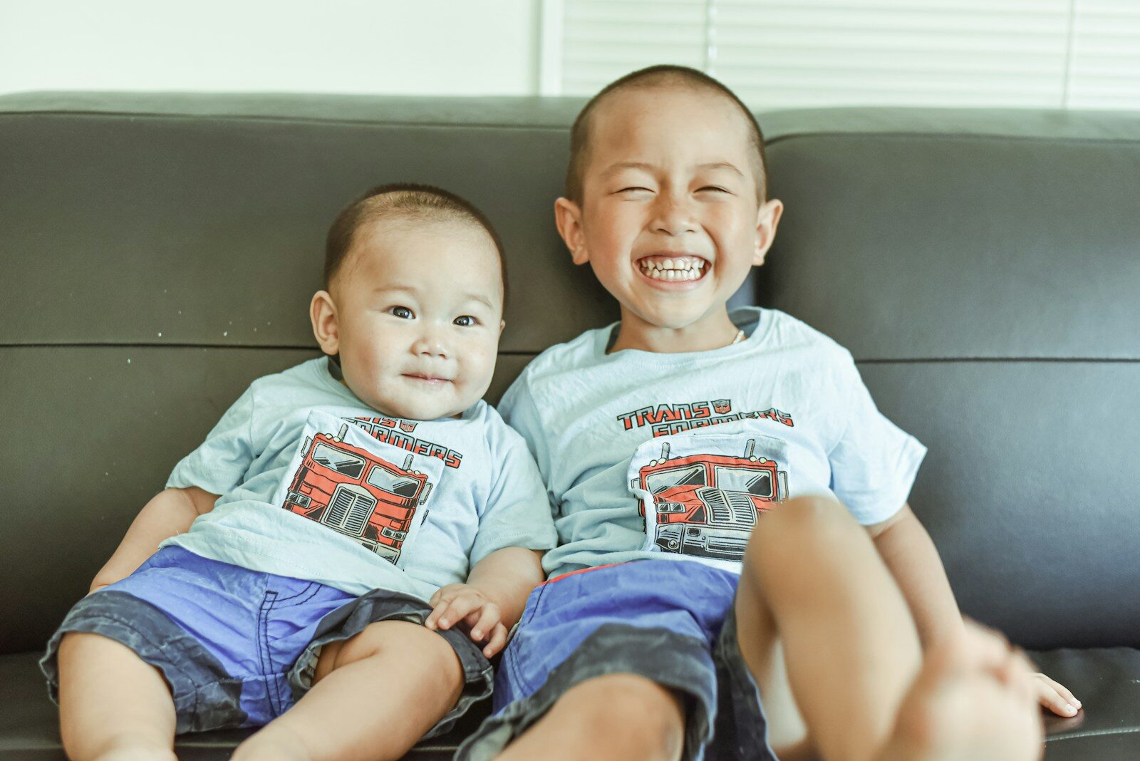 2 boys wearing white crew neck t-shirts