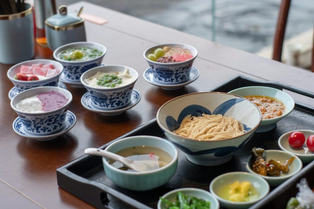 A wooden table topped with bowls of food