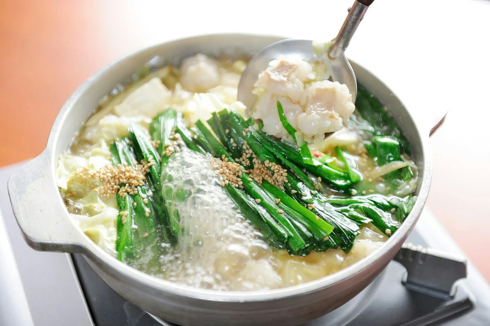 A pot of food on a stove with a spoon
