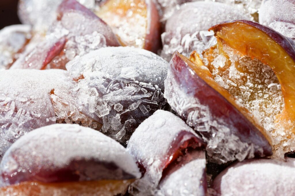 Close-up of mochi with plum filling dusted in powdered sugar.