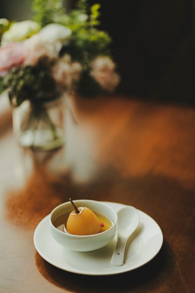 yellow candle on white ceramic saucer