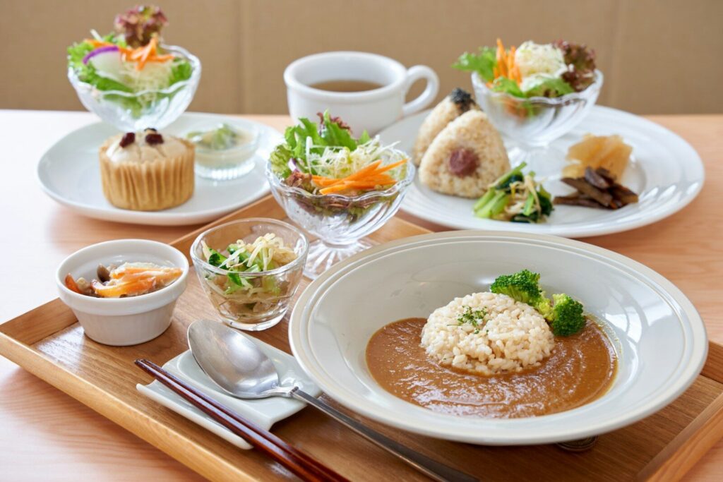 A wooden table topped with plates of food
