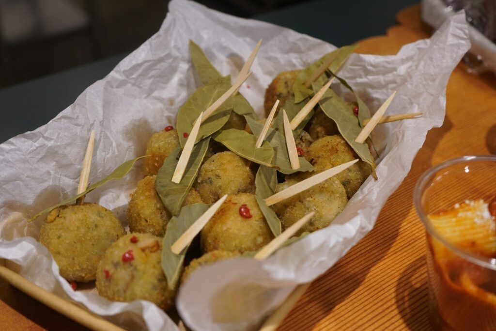Small fried balls with toothpicks and leaves